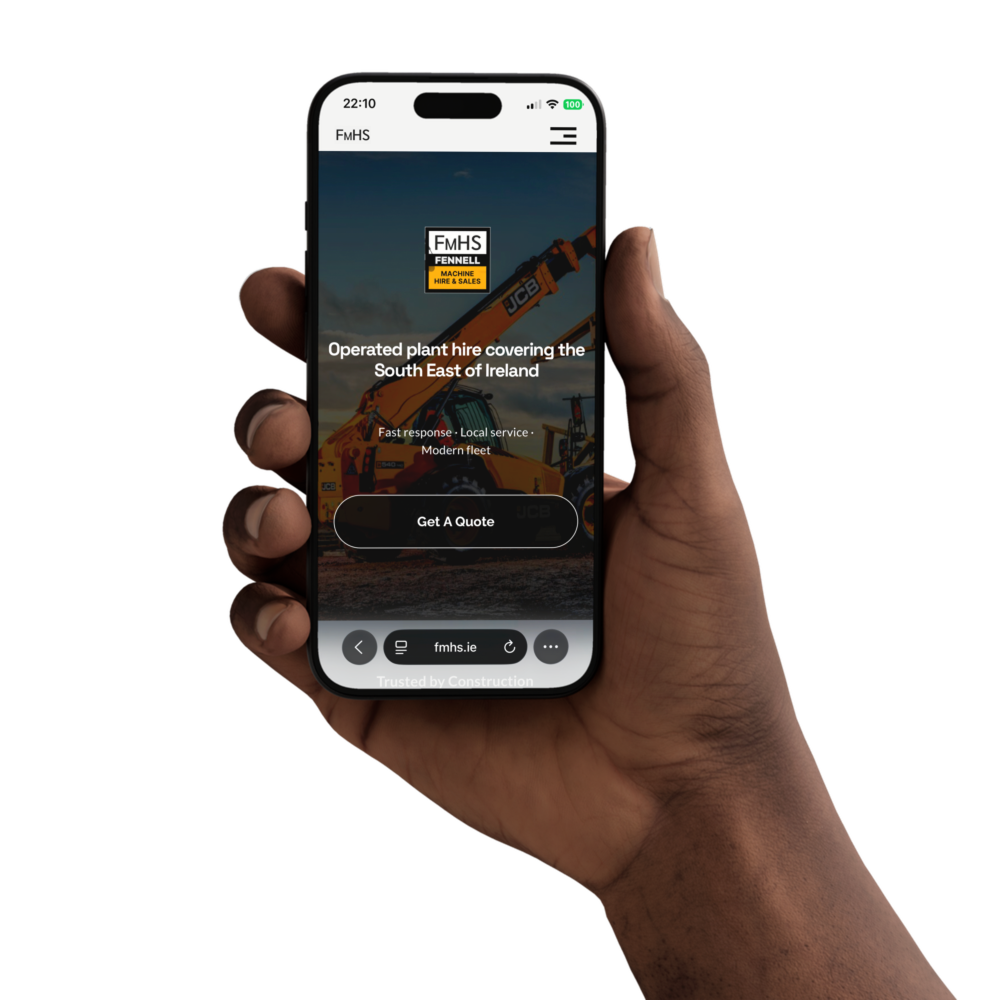 FMHS homepage on a phone held in one hand - the FMHS logo over a telehandler photo, 'Operated plant hire covering the South East of Ireland' and a 'Get A Quote' button